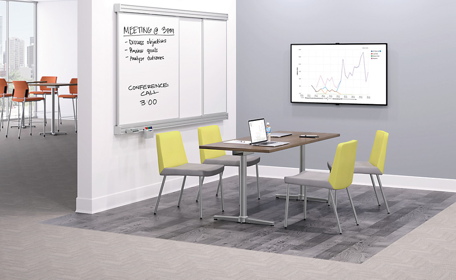 Open meeting room with whiteboard chart, table and four HON chairs