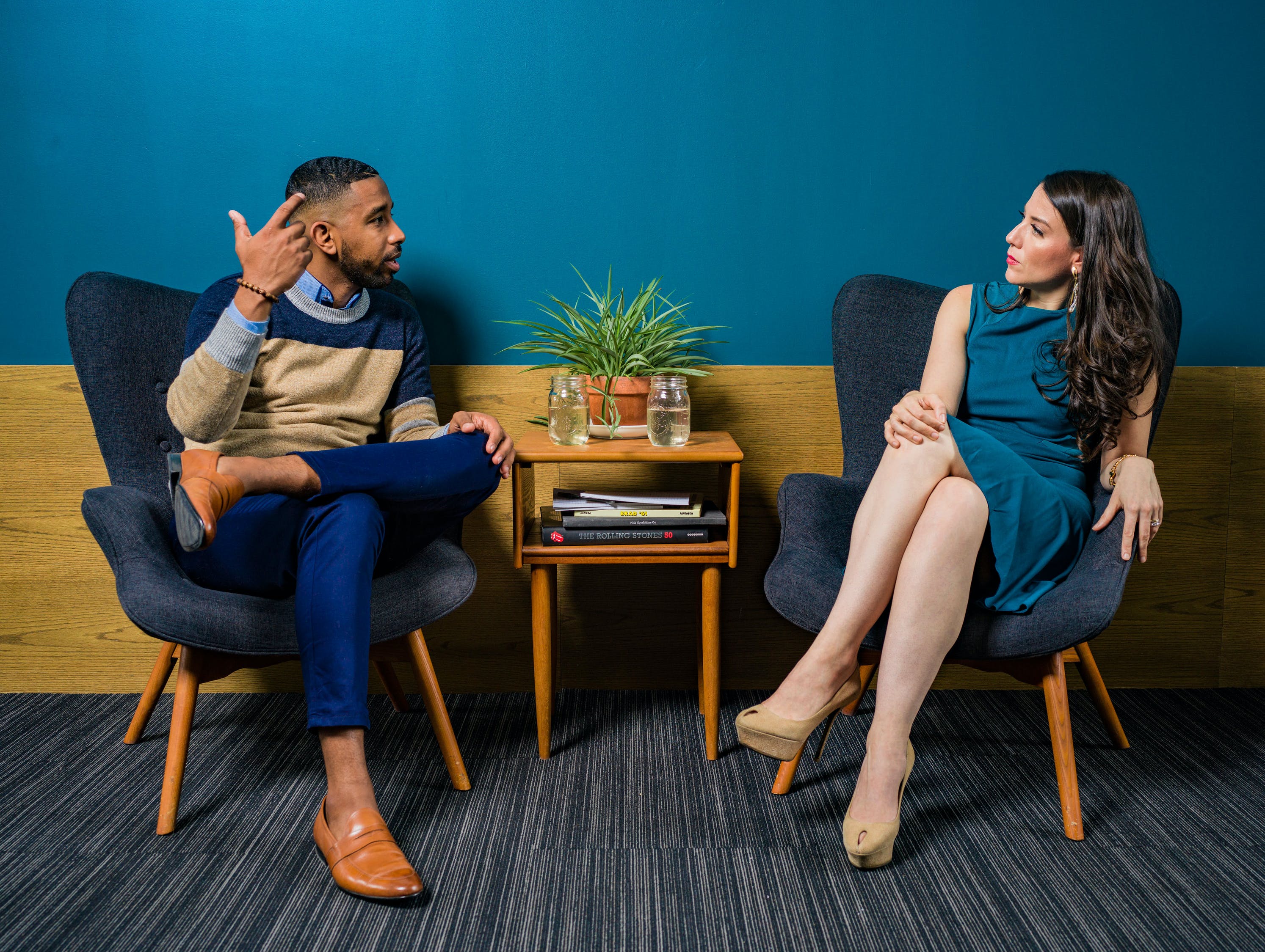 Office Employees Sitting Down, Talking to Each Other