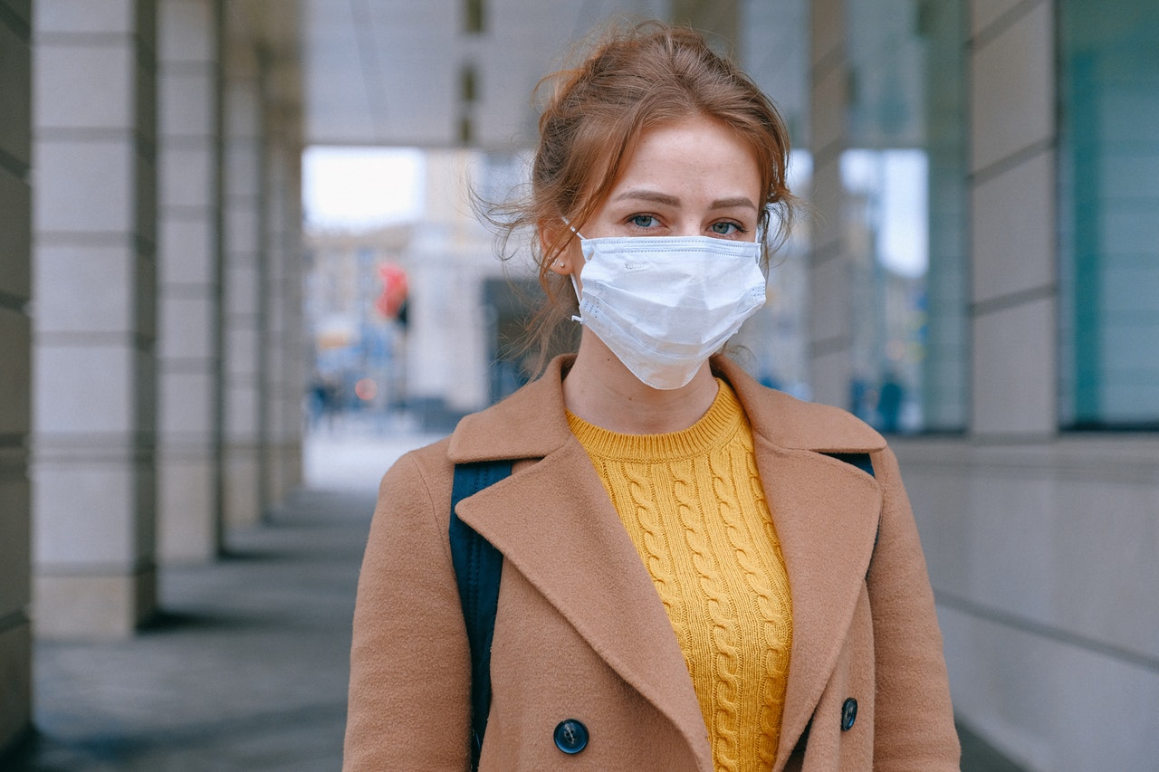 Woman in Brown Suit With Mask Over Face