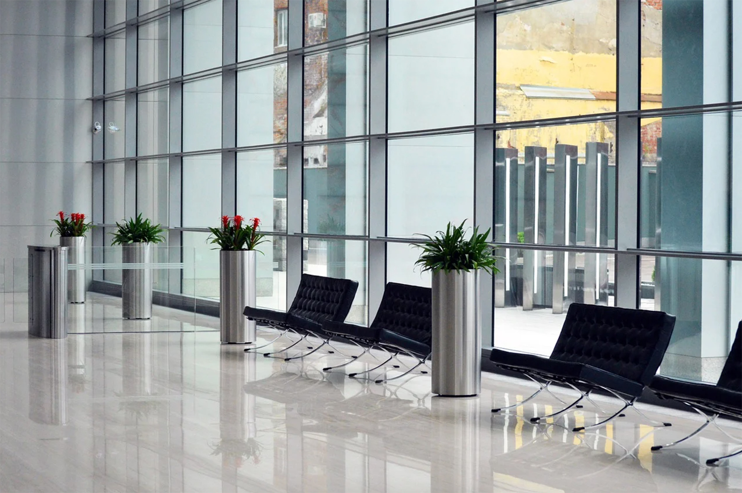 Open Floor Plan Office Entrance with Lots of Windows and Black Leather Chairs