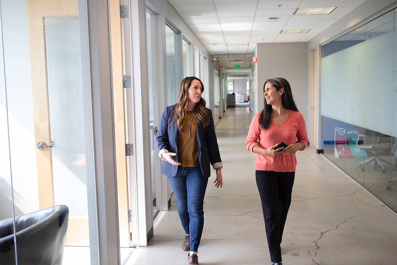 two women taking a walk around the office