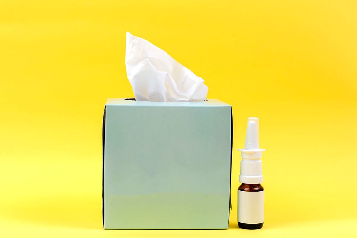 box of tissues and nasal spray,